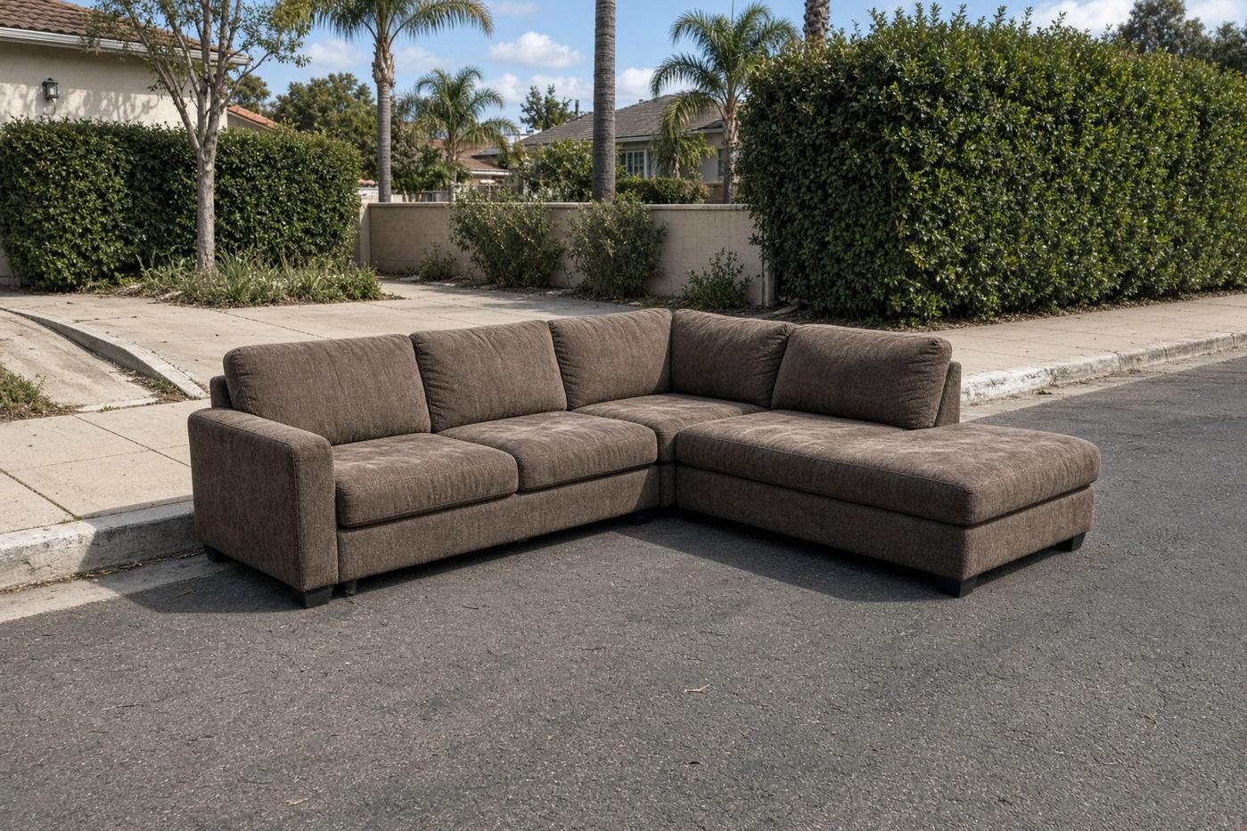 Three-piece sectional sofa at a San Diego curb ready for sectional removal