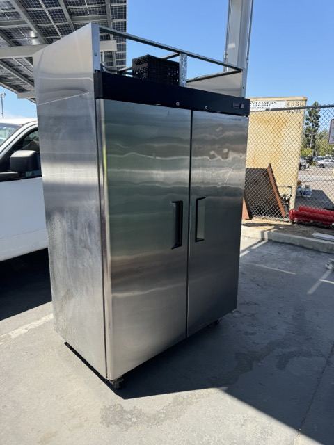 Stainless commercial refrigerator ready for appliance removal in San Diego