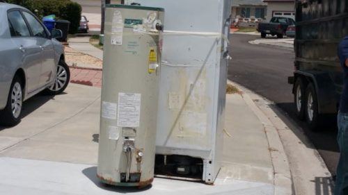 Refrigerator and hot water heater at the curb for haul away