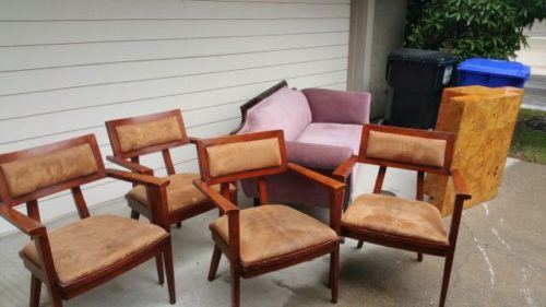 Four dining chairs and a loveseat staged for junk furniture removal