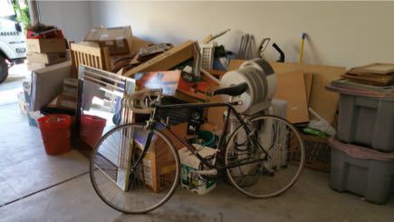San Diego garage with a bike, bins, and boxes staged for hauling