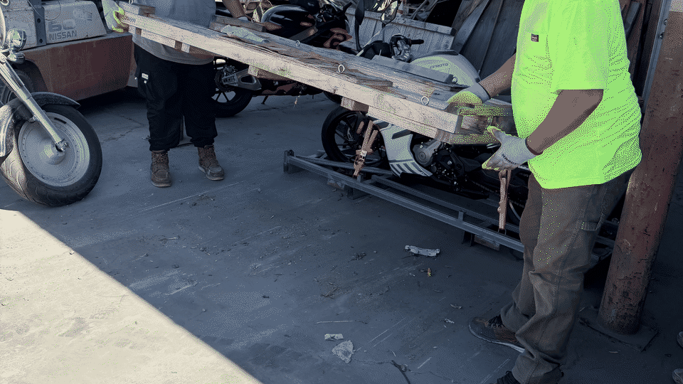 Pallet removal in La Mesa, San Diego. Fred's crew loads a wood shipping pallet into the dump truck at a tow yard.