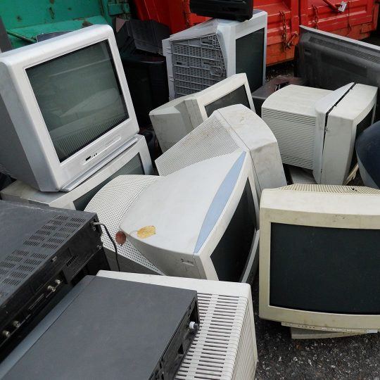 Stack of CRT computer monitors at a recycling yard