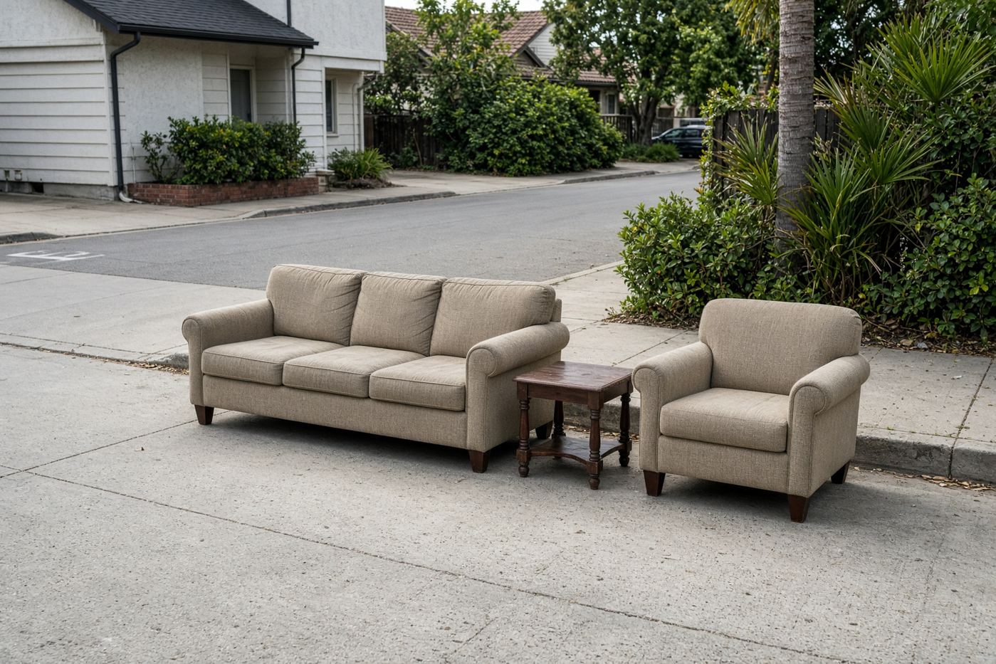 Sofa, chair, and table staged together for a junk removal discount load in San Diego