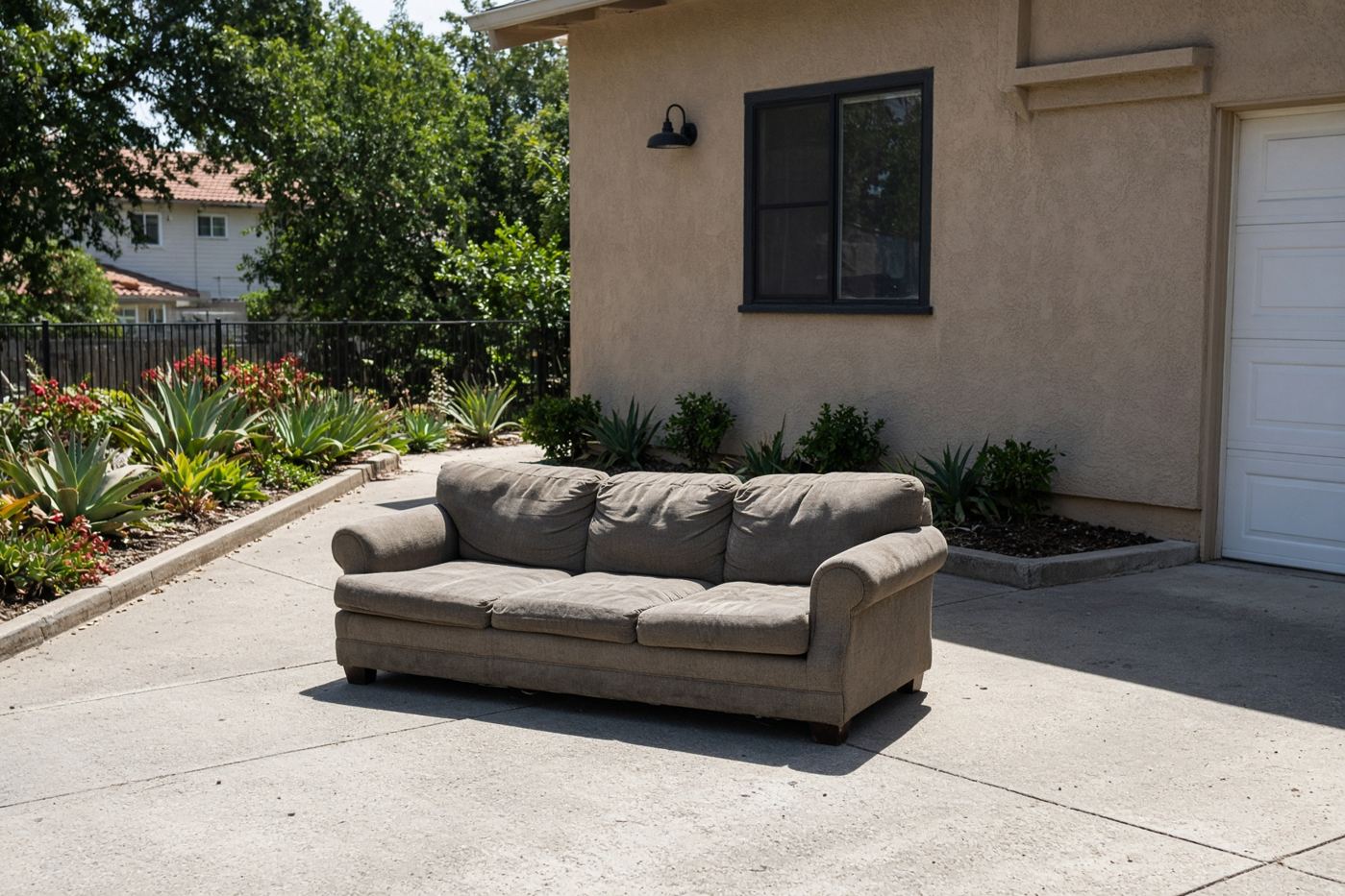Single couch on a San Diego driveway for low price junk removal